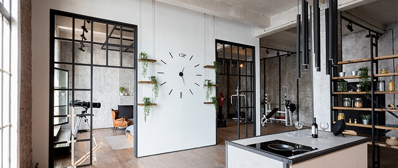 Türen im Loft-Stil mit schwarzen Metallrahmenelementen verbinden Küche und Wohnbereich.